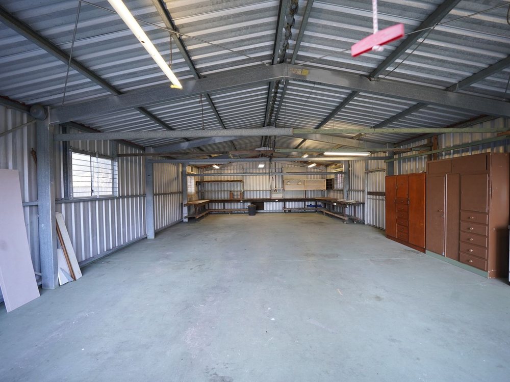 An empty garage with a smooth, seamless coated floor